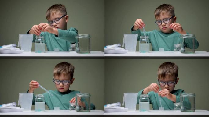 戴眼镜的男孩在室内用移液管和液体进行化学实验。学习，兴趣学习。另类教育。研究背景。成功学习的个人素质