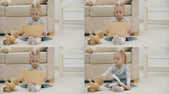 4k视频的金发小女孩手里拿着一本书坐在软玩具旁边。