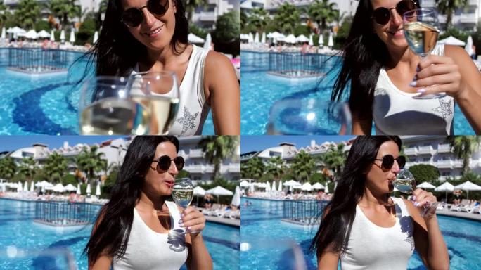 戴着太阳镜的微笑休闲女人在豪华棕榈度假村海滩POV拍摄时碰杯葡萄酒
