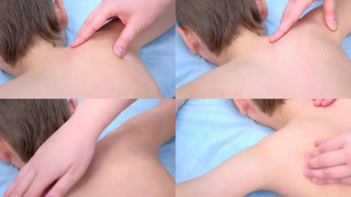 按摩师医生在诊所为肩膀上的青少年男孩做治疗性按摩。