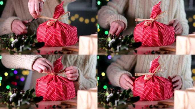 女人用环保可重复使用的可持续布包装圣诞礼物