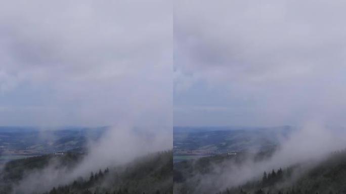 最近下雨后森林的水分蒸发。雾在捷克共和国利贝雷茨地区的je š t ě d山脊上滚动。白色黑暗逐渐来