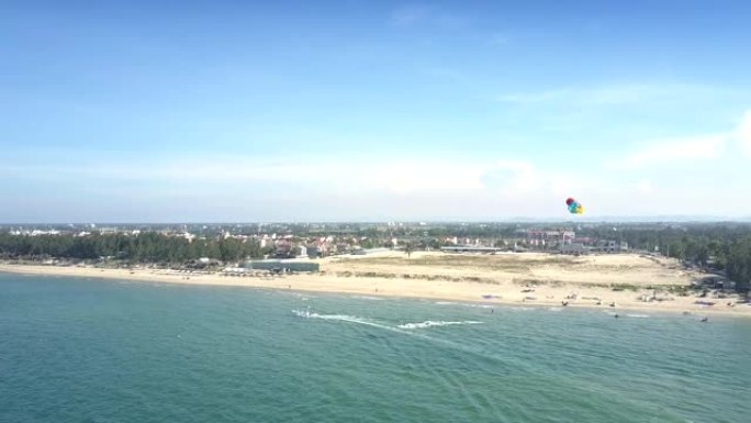 用摩托艇鸟瞰海洋上的彩色降落伞