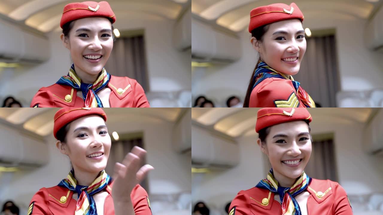 亚洲女性空姐或空乘人员微笑着欢迎乘客登机。
