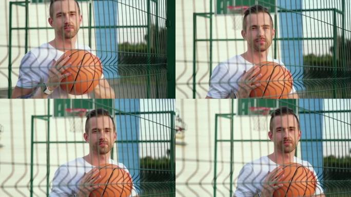 空旷的篮球场上有橙色球的运动型男子，肖像