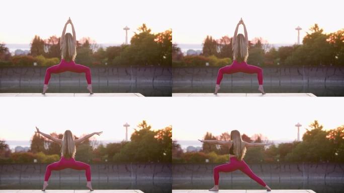瑜伽运动站立姿势系列女神战士2三角美丽年轻成人女性瑜伽模特在城市背景日落剪影