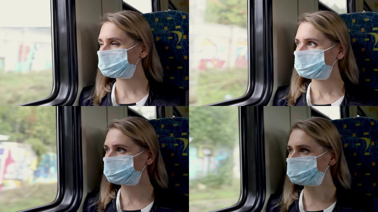 戴着安全面罩的女人坐在火车上，透过窗户看。病毒大流行