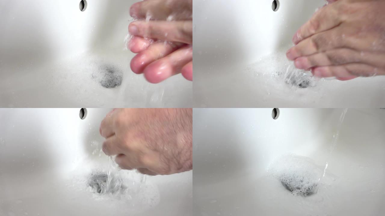 男子洗手电晕病毒保护用肥皂在白色水槽与流水