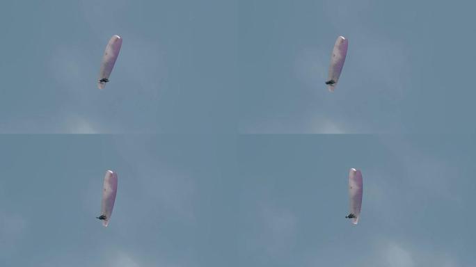 游客喜欢在湛蓝的天空慢动作下滑翔伞