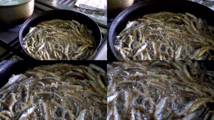 凤尾鱼在热锅中煎炸，厨房