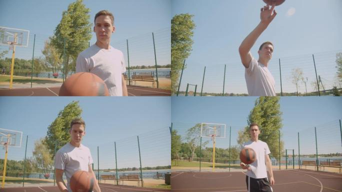 年轻的高加索男子篮球运动员的特写肖像用手指旋转球看着户外球场上的相机，背景是桥