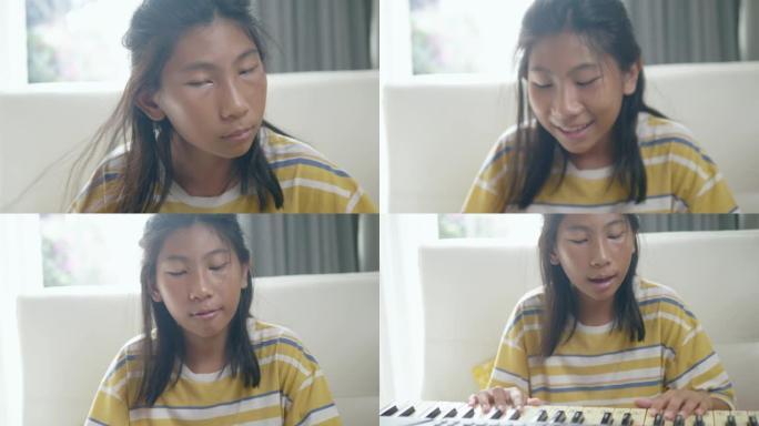 快乐的亚洲女孩在家练习键盘乐器技能，生活方式理念。