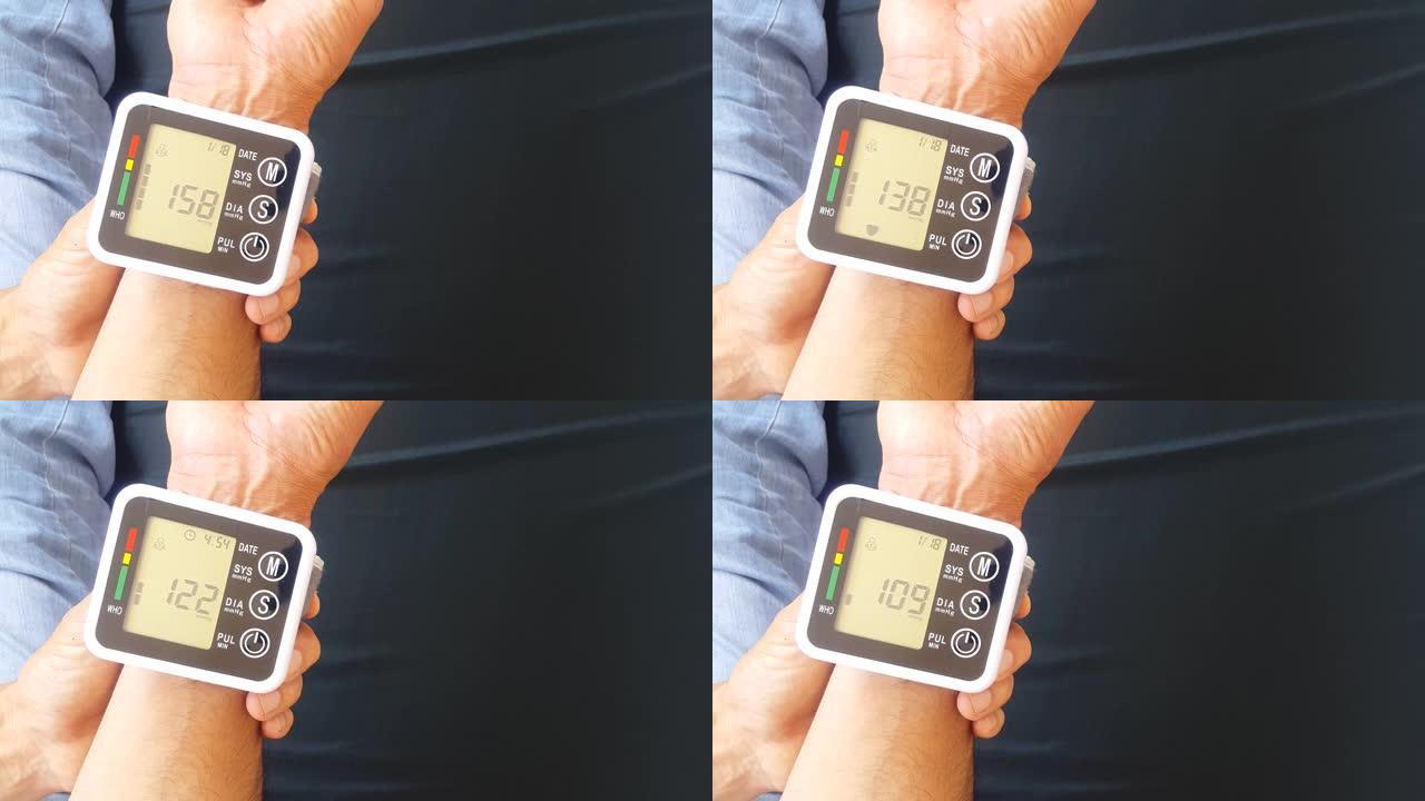 使用便携式设备在家中测量血压，以检查您的健康状况。该装置显示高压值。