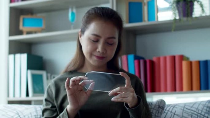 年轻女子在智能手机上使用高科技隐形全息虚拟