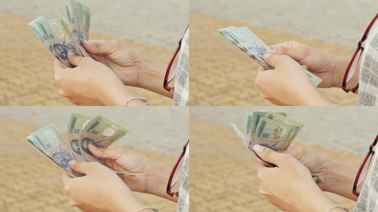 越南女孩讲述越南盾。手和钞票特写