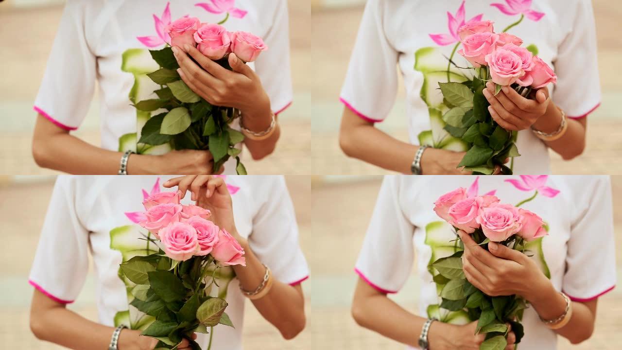 越南女孩手持一束粉红玫瑰