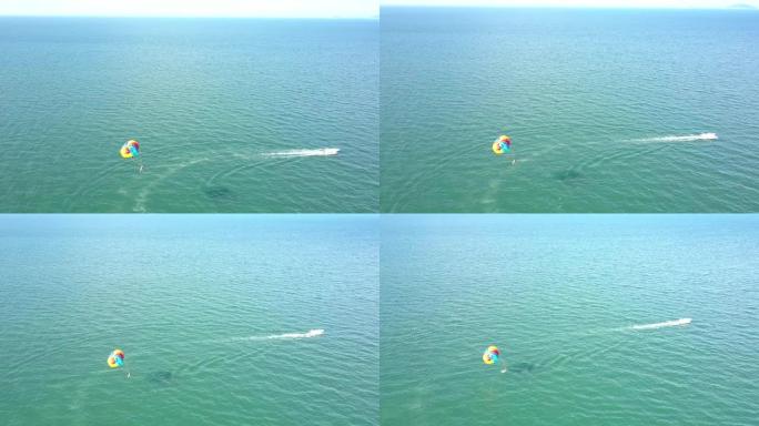 鸟瞰图降落伞在海上的白色摩托艇后面飞行