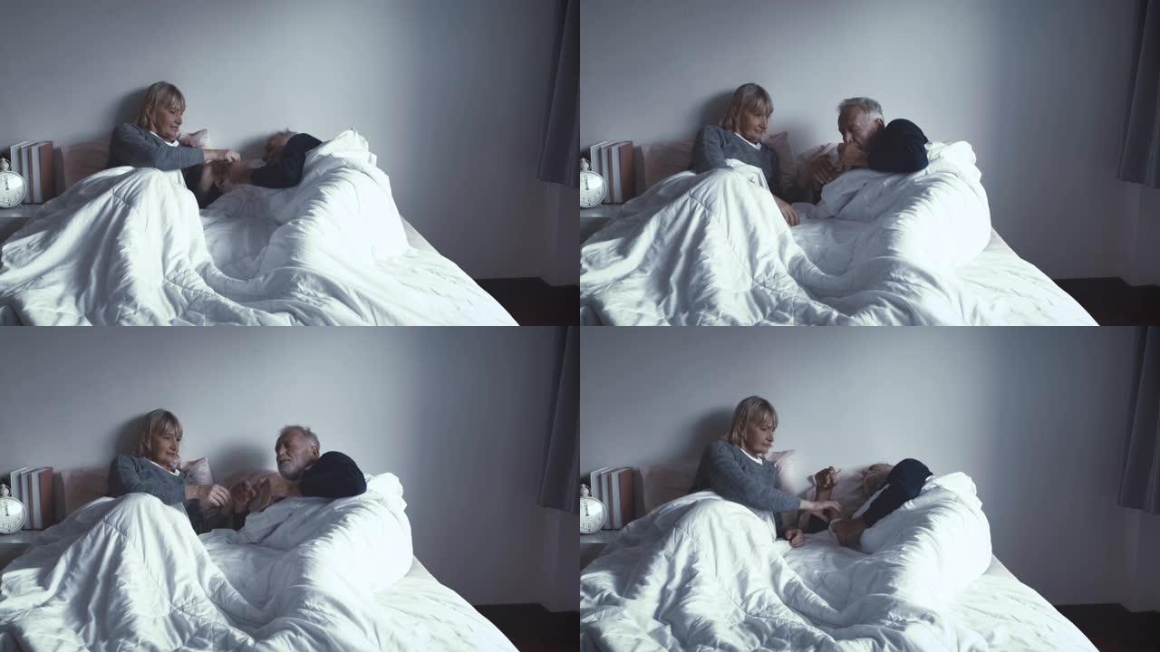 年长的高加索老妇人醒来，晚上在卧室生病时给男人吃药