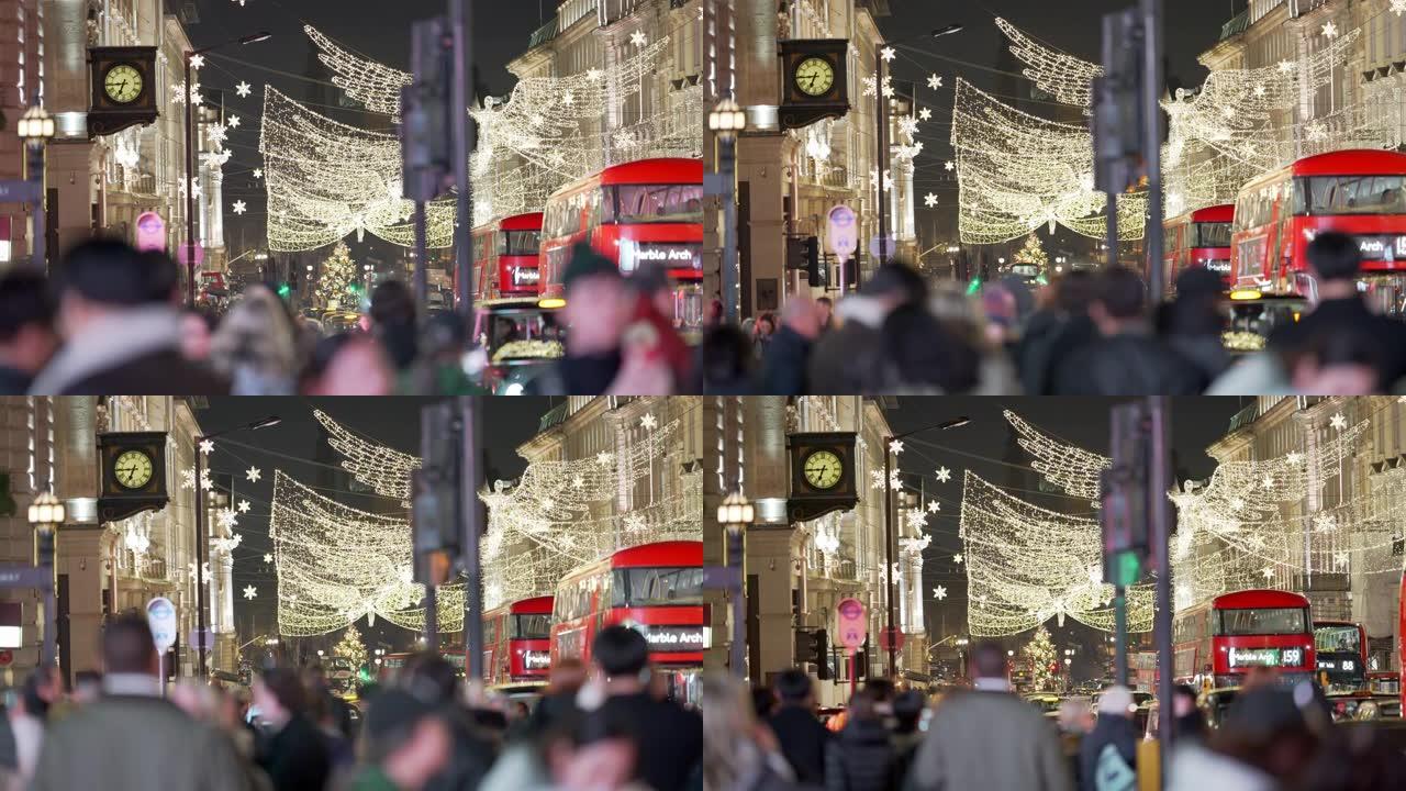 在一个繁忙的冬夜，伦敦的圣诞灯火穿过人群和交通。