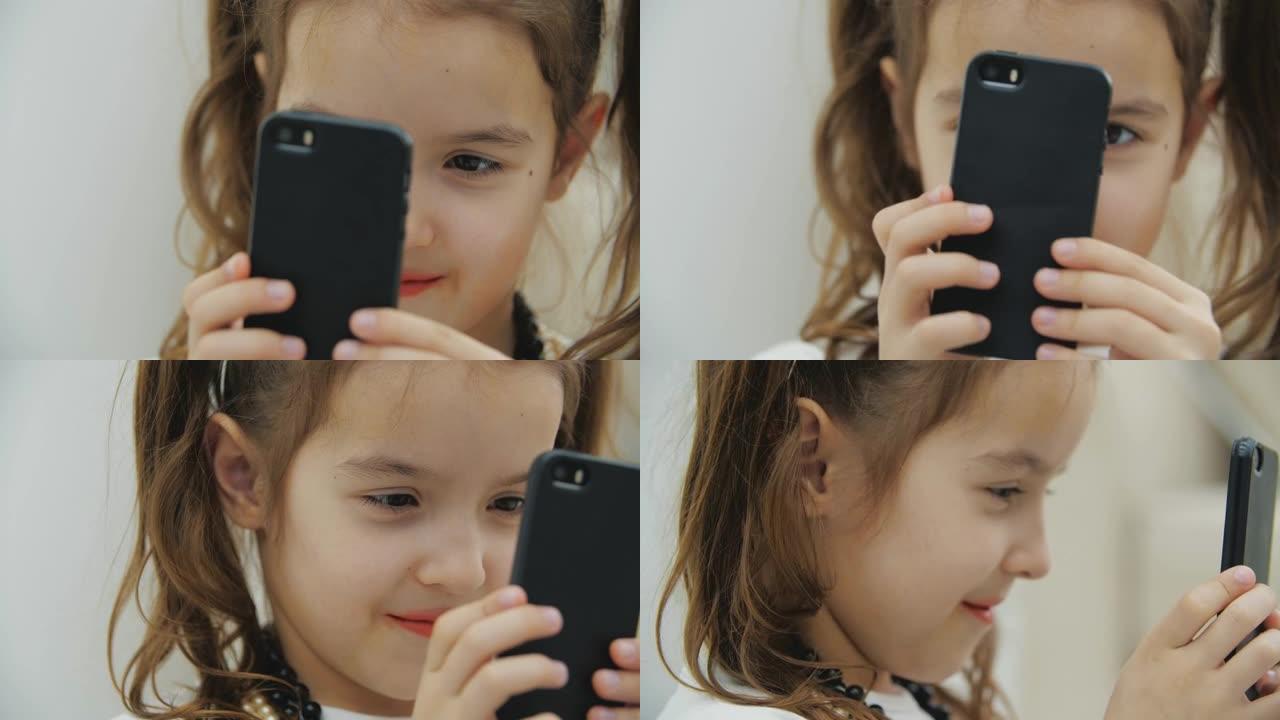 剪短的视频，小辫子的可爱小女孩戴着项链和头套，拿着黑色手机，拍照。