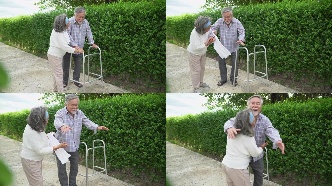 亚洲老夫妇和沃克一起在家散步。高级男子在公园里使用助行器与年长的女人一起工作。成熟的丈夫和妻子在花园