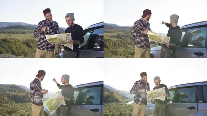 两个朋友站在汽车旁喝茶，同时看着路线图，沿着进一步的路线爬山，笑着说话。开车在山里旅行。大自然，户外
