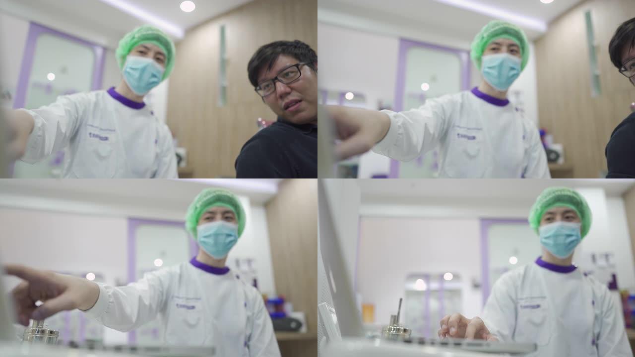 亚洲男性牙医向患者解释程序
