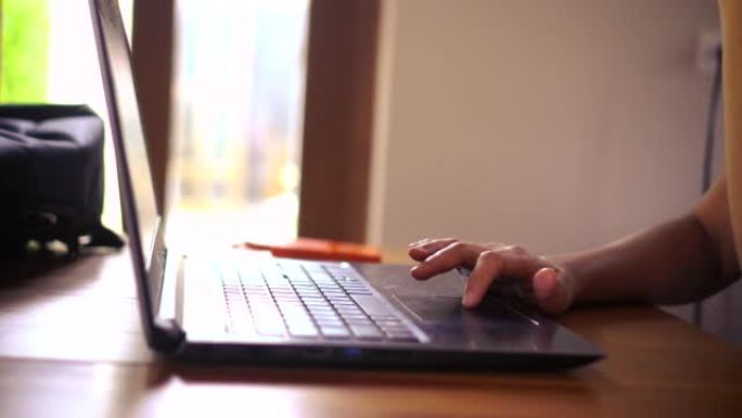 4k视频选择性聚焦女人用笔记本电脑在自然背景上做工作、学习和上网。