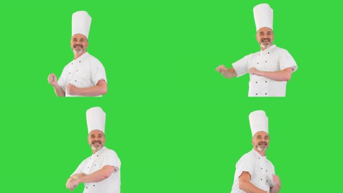 成熟的厨师，留着胡须，穿着白色制服，在绿色屏幕上跳舞，色键