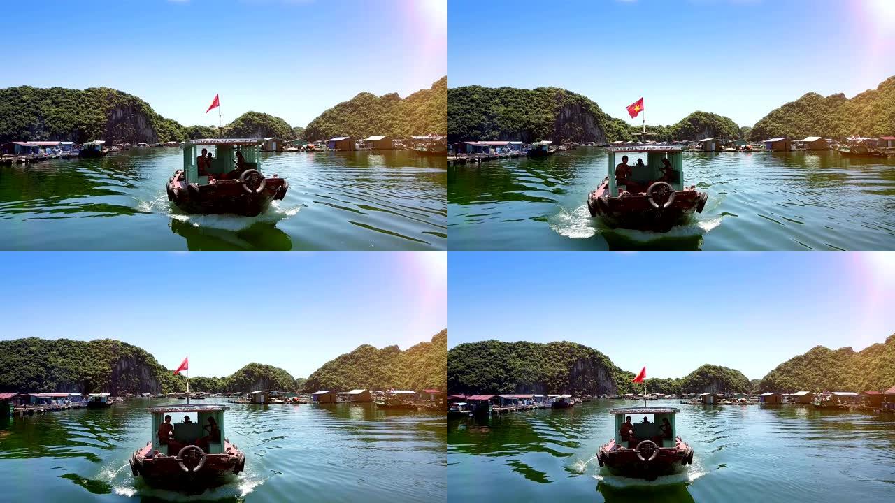 带有游客的摩托艇在海湾上驶向浮动村庄