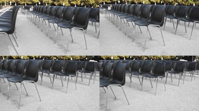 一排排空的黑色塑料椅子准备进行户外表演