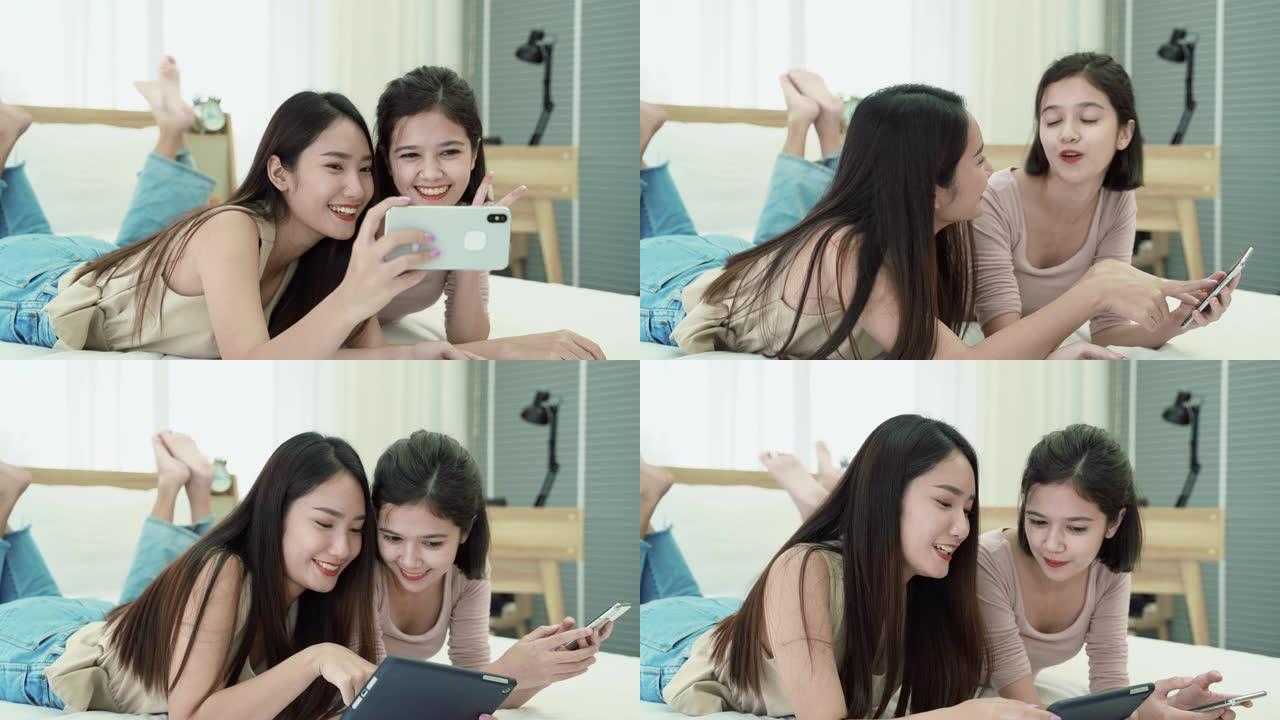 两位相亲相亲的亚洲美少女使用手机在社交媒体上传照片。