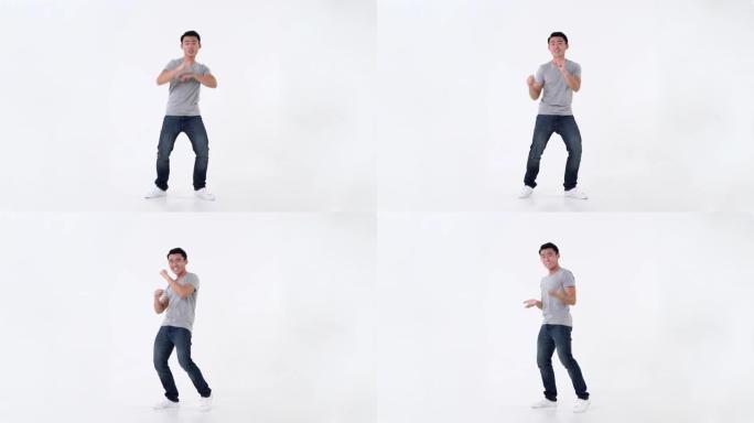 快乐的亚洲男人玩得开心，在白色背景上跳舞