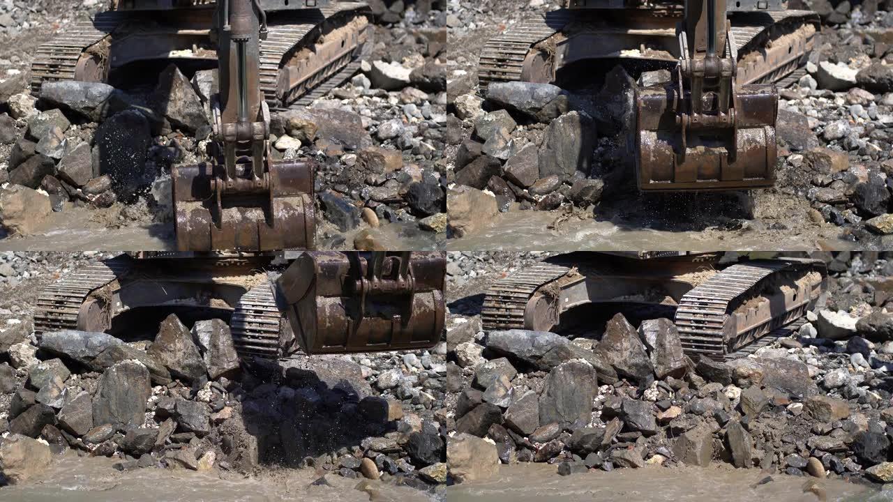 工业挖掘机在河中工作，在建筑工地提取岩石和鹅卵石