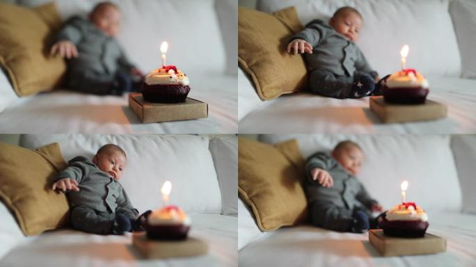 新生婴儿生命的第一个月庆祝蛋糕上的烛光