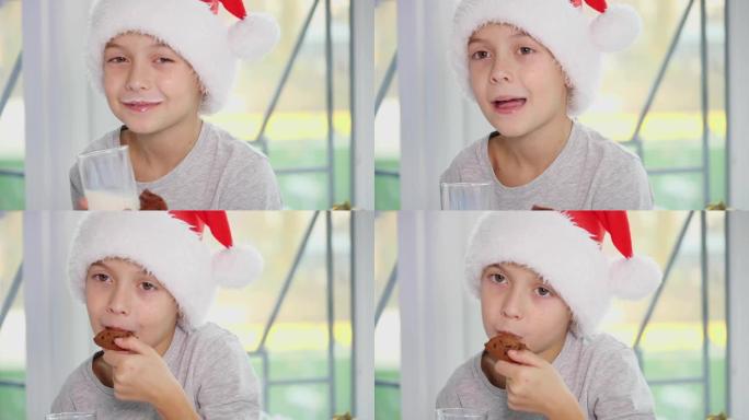 裁剪4k视频，小男孩戴着圣诞老人帽子喝牛奶，吃美味的饼干，舔牛奶胡子。