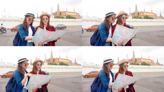 女人和朋友在看地图。亚洲女人喜欢在泰国唐人街旅行