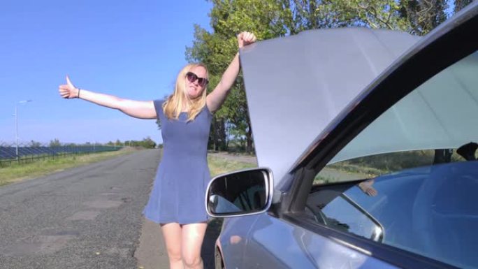 一个穿着蓝色太阳裙的金发女郎在她的车附近的路上投票。打开的引擎盖表示车辆发生故障。在困难的情况下帮助