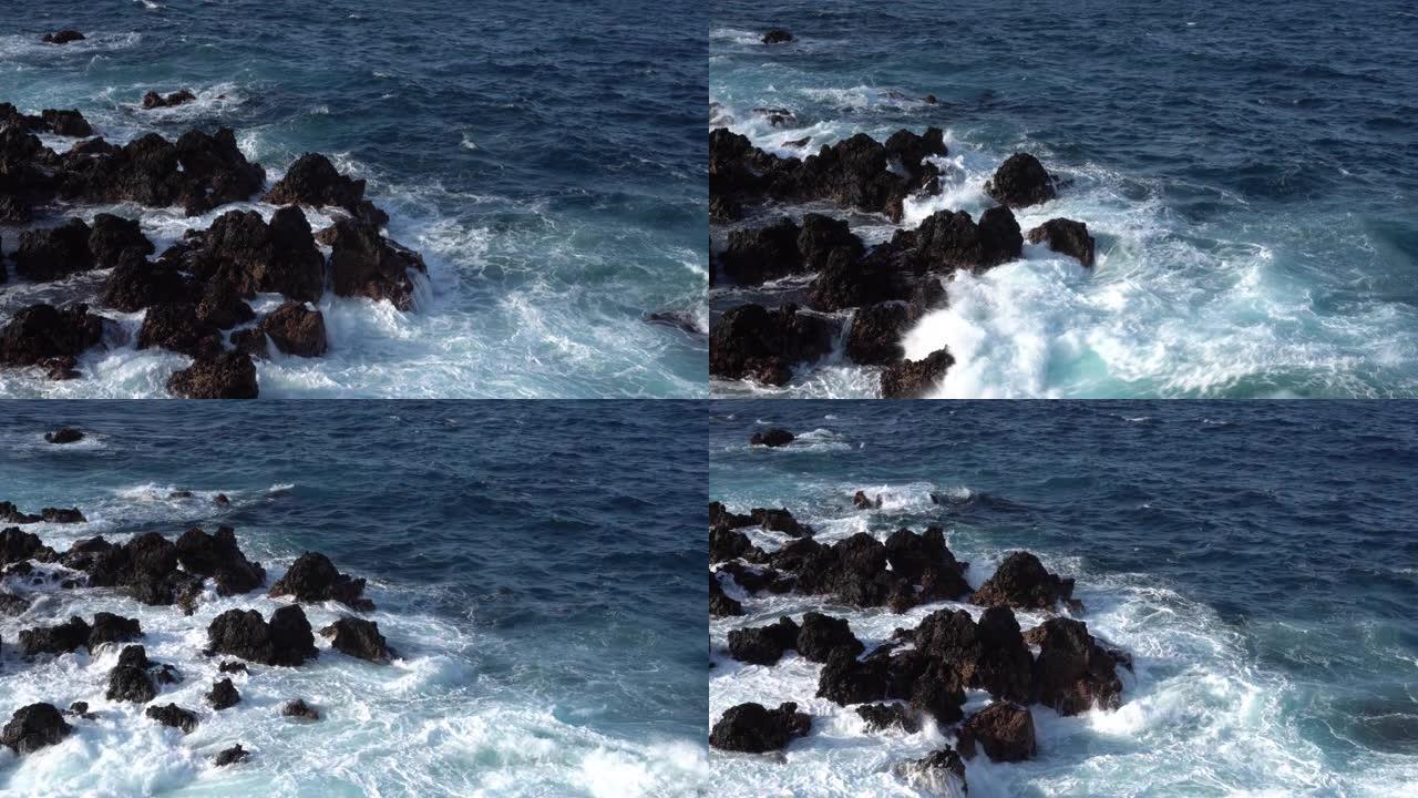 白浪在大西洋沿岸的黑色熔岩上坠毁