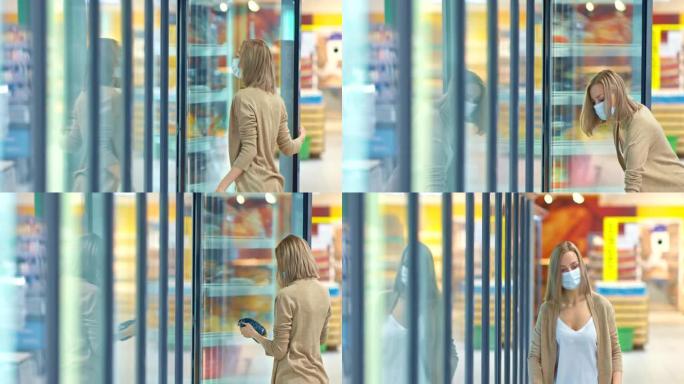 戴着医用口罩的女人去超市的冰箱，取出冷冻食品。在检疫期间为新型冠状病毒肺炎购买食物，冠状病毒。4k，