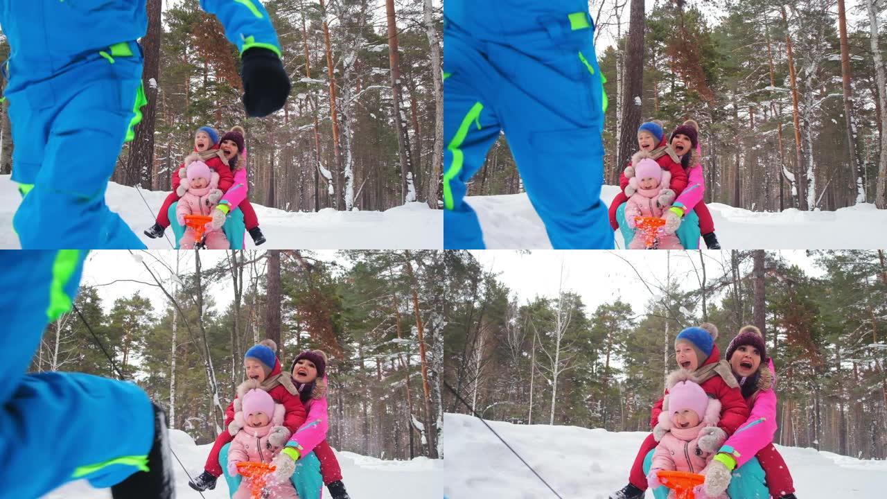 家庭骑在雪橇上，父亲奔跑拉吊带车