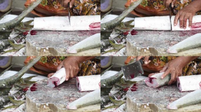 当地妇女在人行道上切割鲜鱼，街头食品