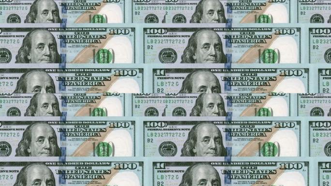 一个特写镜头在多个美国100美元钞票上平移-无缝循环