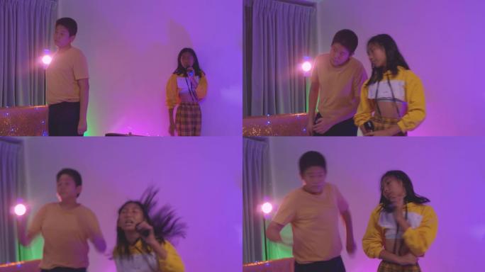 快乐的亚洲孩子在房子的派对上一起跳舞，用发光二极管灯，生活方式概念。