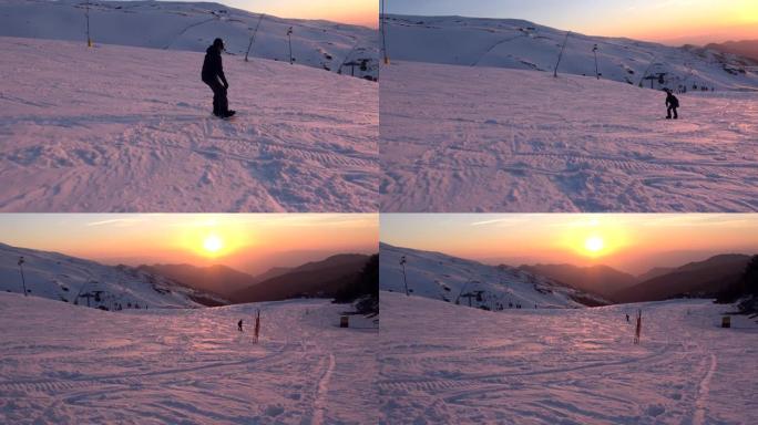 4K.一名滑雪者从雪中升起，从山上滑下，日落-阿德里安。