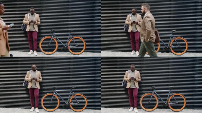 非洲裔美国人站在自行车上并使用智能手机