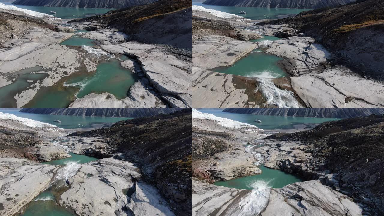 缓慢的空中无人机沿着加拿大山姆福特峡湾附近的河流行驶，格陵兰岛附近