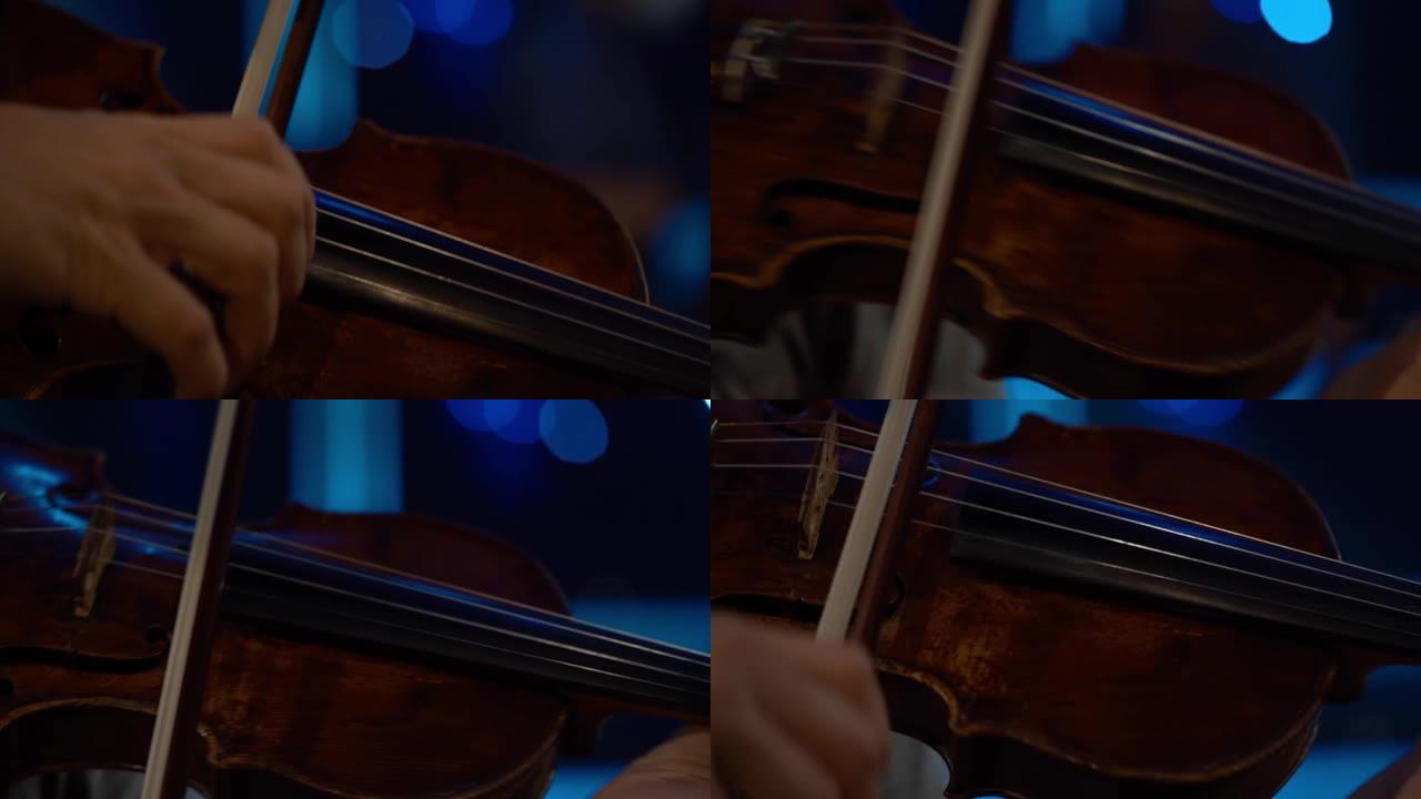 细节镜头，小提琴家男人在舞台上的表演，浅色，深色背景