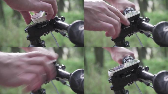 自行车手的特写镜头使用小工具进行GPS导航，建造和遵循计划的训练路线。男子触摸按钮设备活动跟踪器，记
