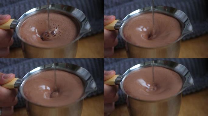 在钢罐中混合热巧克力。舒适的食物概念